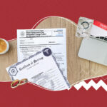 A marriage certificate along with a name change application, a laptop, and a cup of coffee