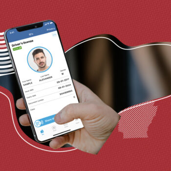 A hand holding a smartphone displaying a digital driver’s license on the screen, showing a photo of a man with short hair and beard, named Sample Alexander. The license details include issue date, expiry date, document number, and class. The background has a red textured design with abstract shapes.