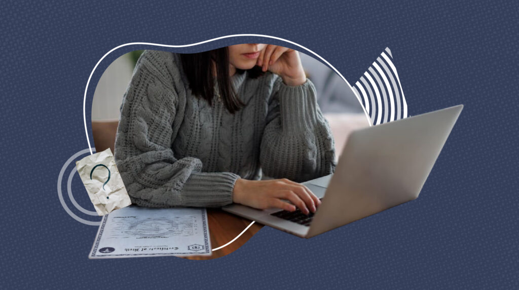 Person wearing a gray sweater sitting at a desk using a laptop, with a death certificate partially visible on the table. A crumpled paper with a question mark is placed beside the document, symbolizing confusion or inquiry about official records or personal documentation.