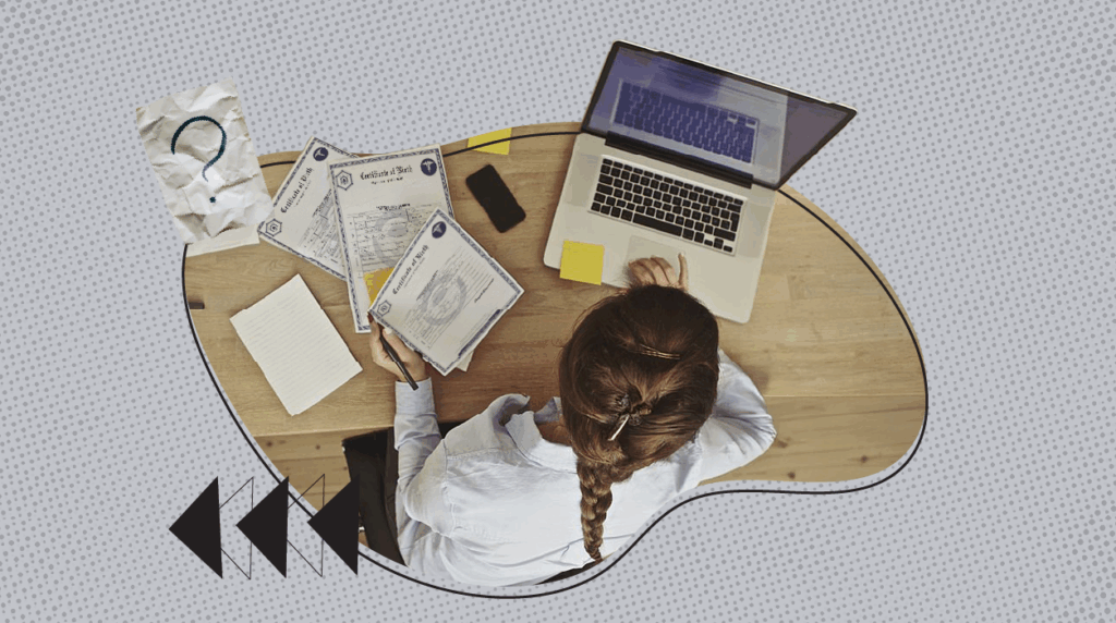 A woman with a braid works on a laptop at a wooden desk, surrounded by birth certificates, a notepad, and sticky notes. A crumpled paper with a question mark and abstract arrows are part of the graphic design, symbolizing research or clarification about vital record requests and document access. The background features a dotted gray pattern with curved lines for a modern look.
